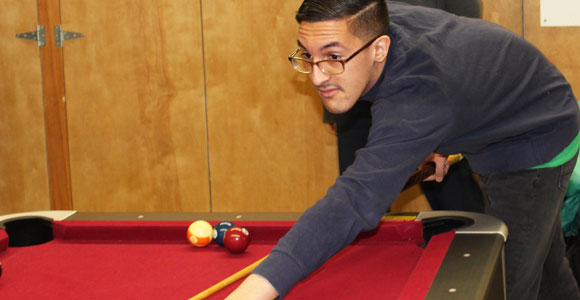 Student at a billards table