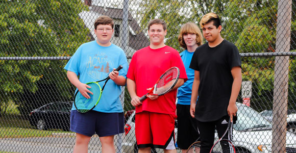 Student tennis players at special needs school