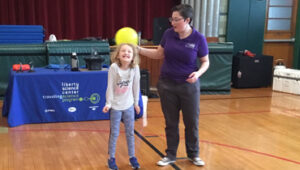 Student playing in a school gym